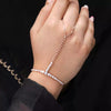 Hand wearing a delicate bracelet with a black background