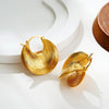 Bold gold-tone textured hoop earrings with ripple design – statement jewelry for women