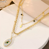 Gold-plated layered chain necklace with green heart stone and oval pendant – TrioShine