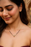 Woman wearing a necklace with a blurred background