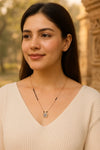 Woman wearing a necklace with a blurred background