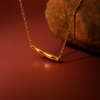 Close-up of minimalist gold bamboo bar necklace – nature inspired jewelry for women