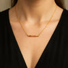 Minimalist gold bamboo bar necklace on woman model – elegant everyday pendant chain jewelry