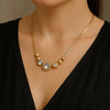 Gold beaded crystal statement necklace on woman model – luxury party wear jewelry