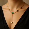 Gold heart and green stone Y-shaped necklace on woman model – elegant pendant chain jewelry