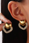 Gold heart stud earrings worn on ear – elegant fashion jewelry for women