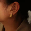  Elegant gold knot stud earrings worn on ear – minimalist gold earrings for women